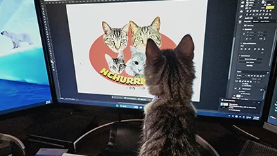 Bella Grace looking at NCHurricats artwork on a monitor